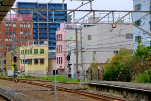 Colorful urban scene of a railway station amidst modern architecture in Japan.
